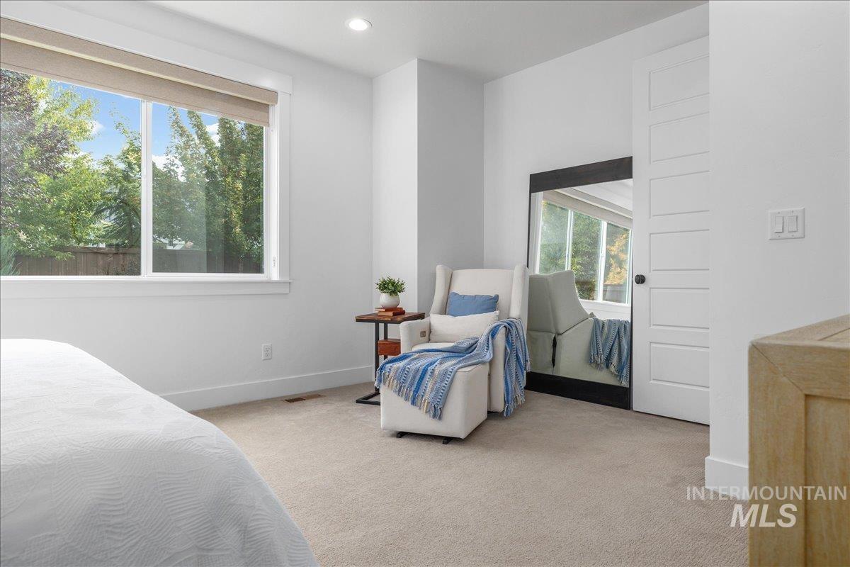 Carpeted bedroom with baseboards and recessed lighting