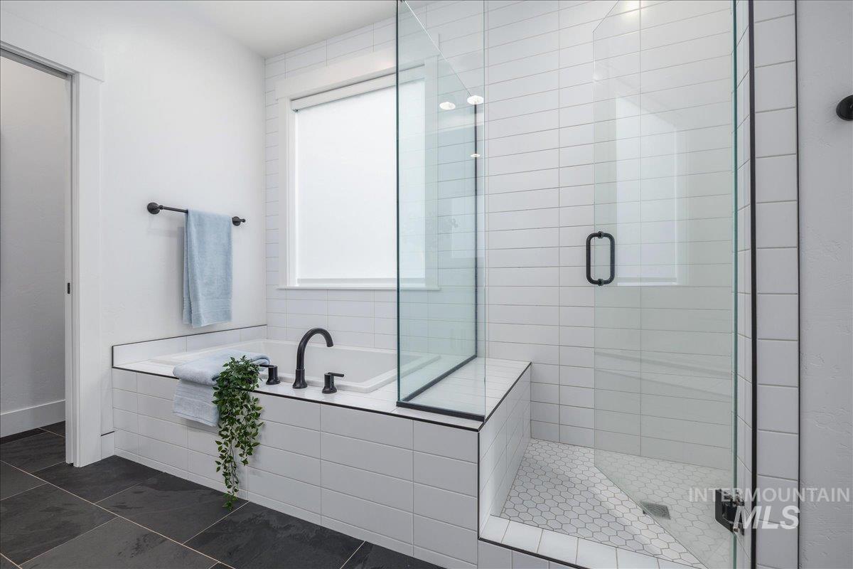Full bath with a shower stall and a garden tub