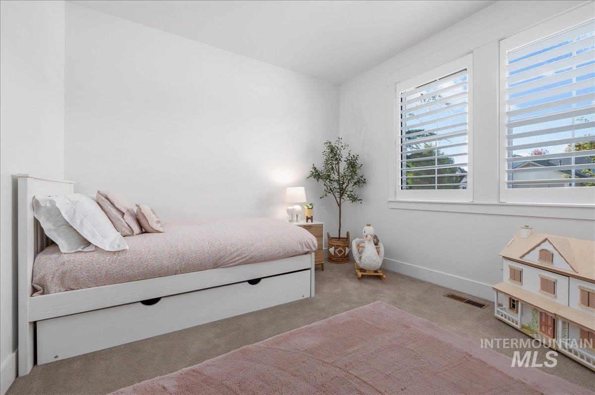 Carpeted bedroom featuring baseboards