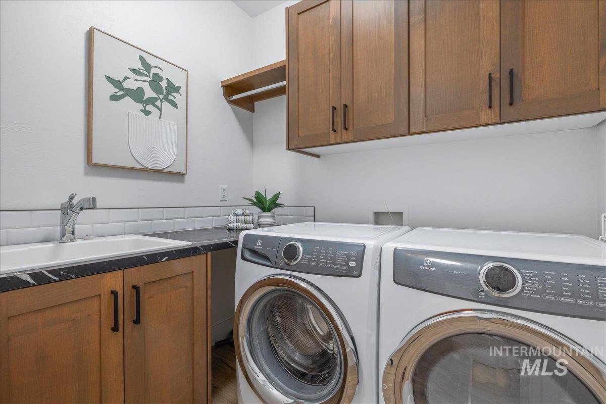 Laundry room featuring cabinet space and independent washer and dryer
