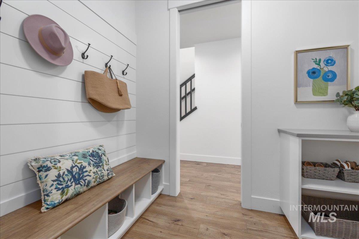 Mudroom featuring light wood-type flooring and baseboards