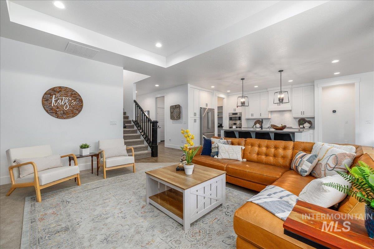 Living room with stairway and recessed lighting