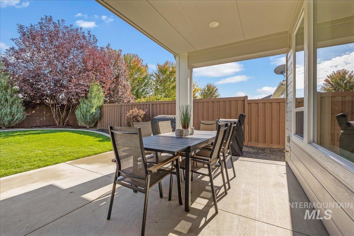 Fenced backyard with outdoor dining area and a patio area