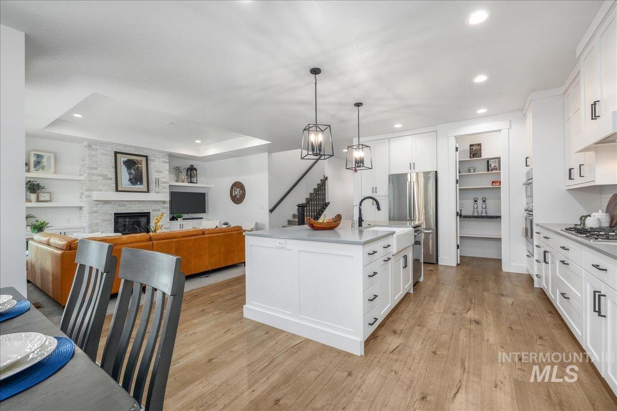Kitchen with white cabinetry, open floor plan, pendant lighting, and recessed lighting