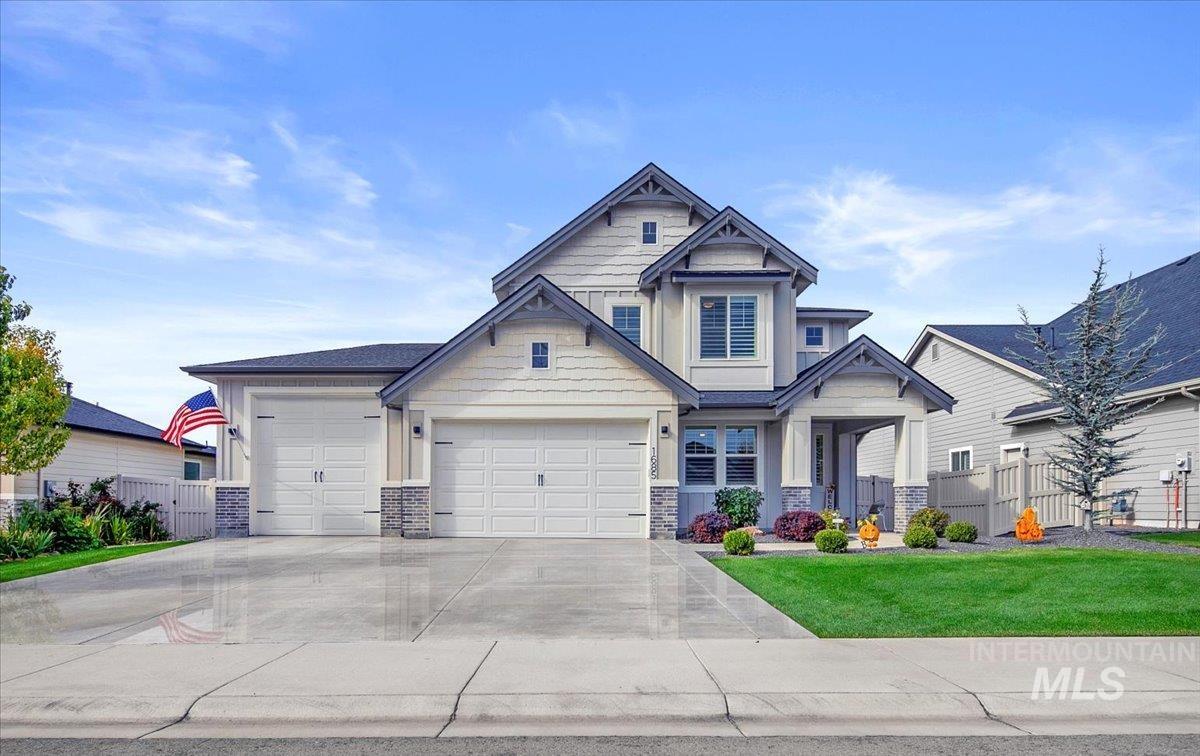 Craftsman-style home featuring concrete driveway, a garage, and stone siding