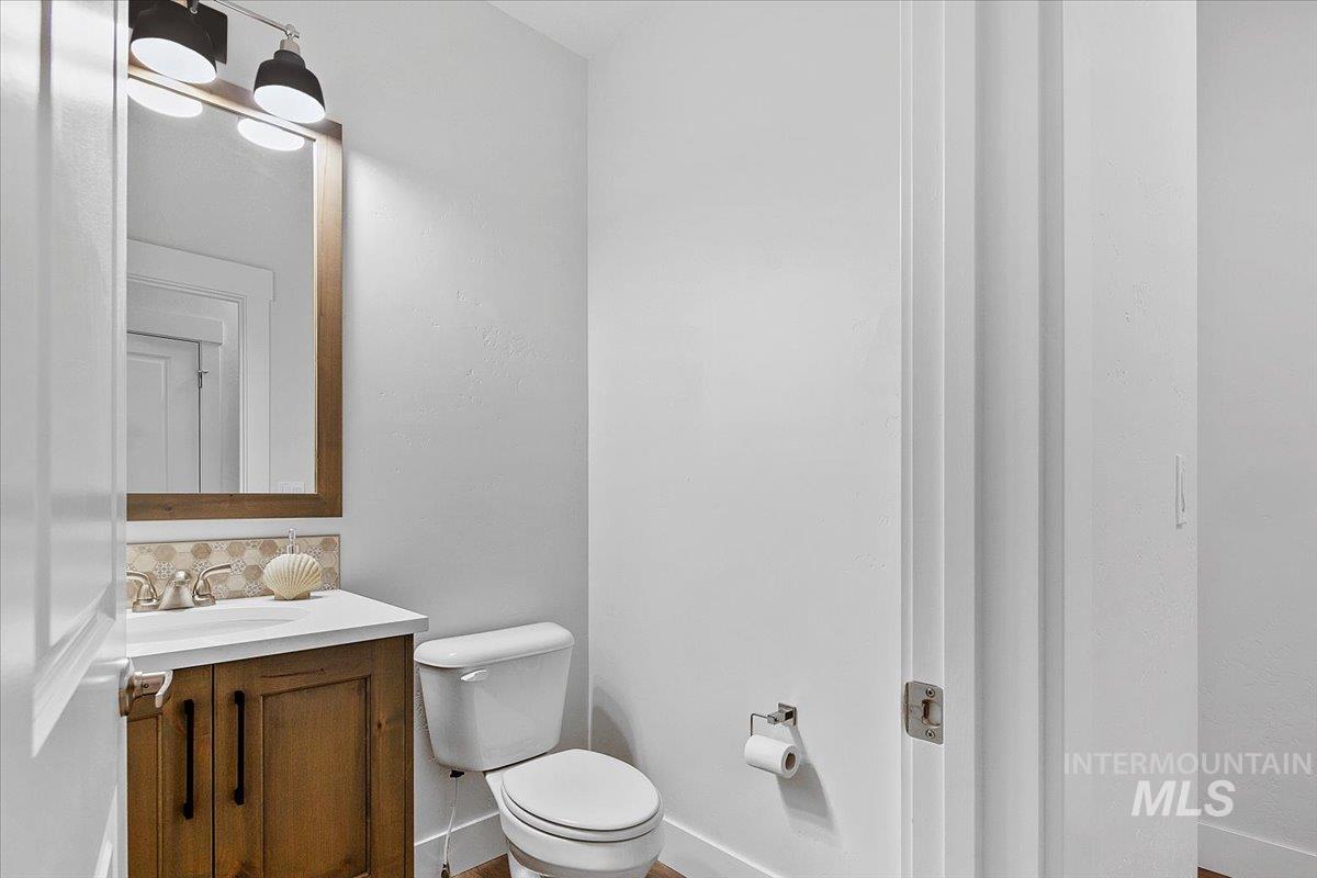 Bathroom featuring vanity and tasteful backsplash