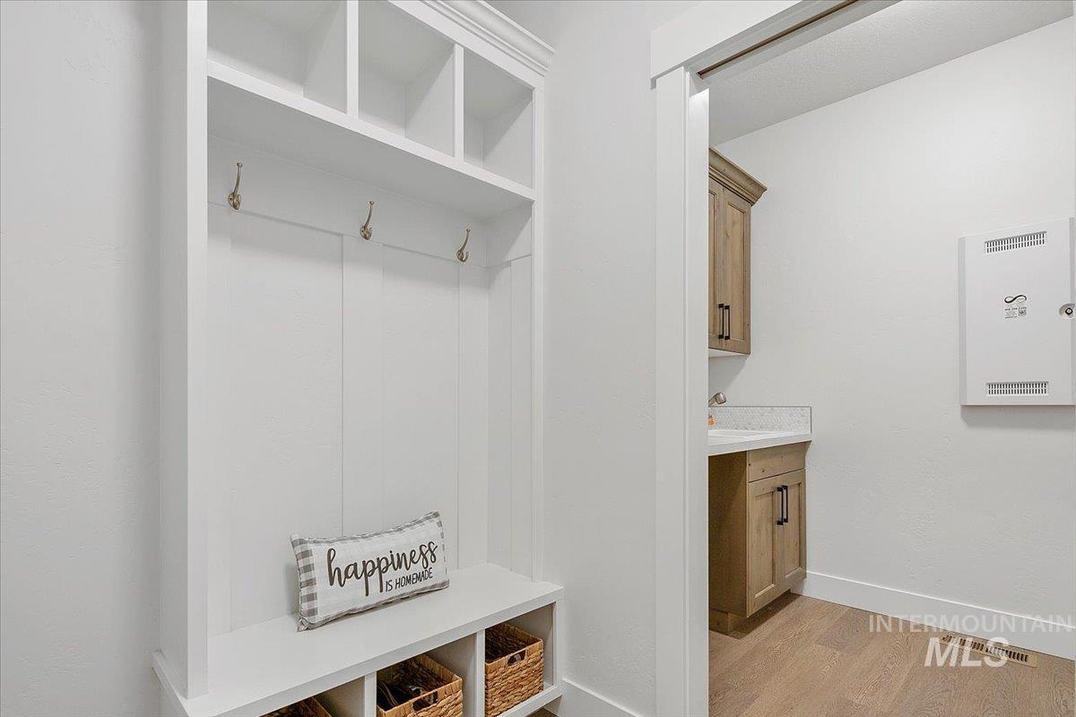 Mudroom featuring light wood-style floors and baseboards