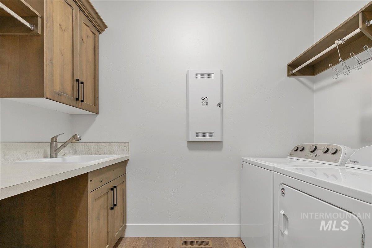 Laundry area featuring washer and dryer and baseboards
