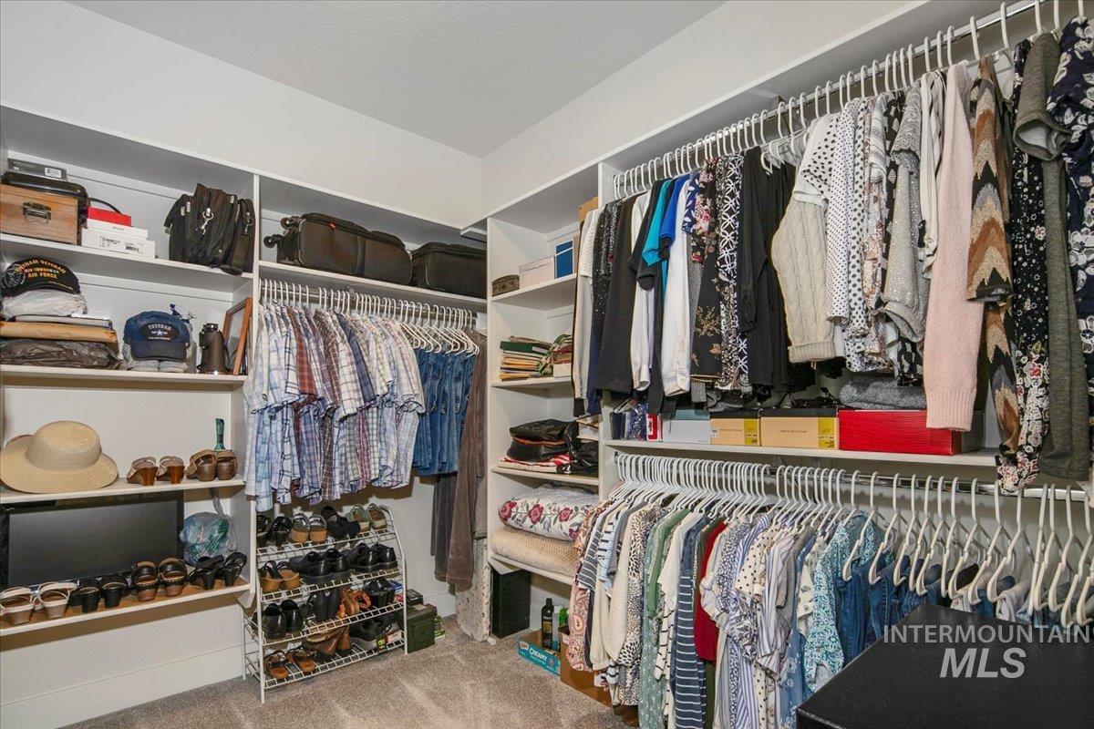 Spacious closet with light carpet