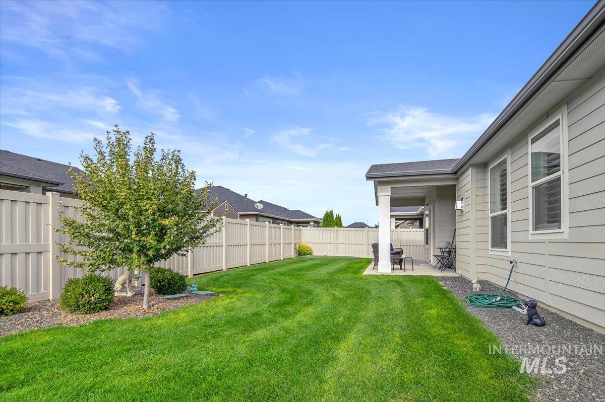 Fenced backyard with a patio area