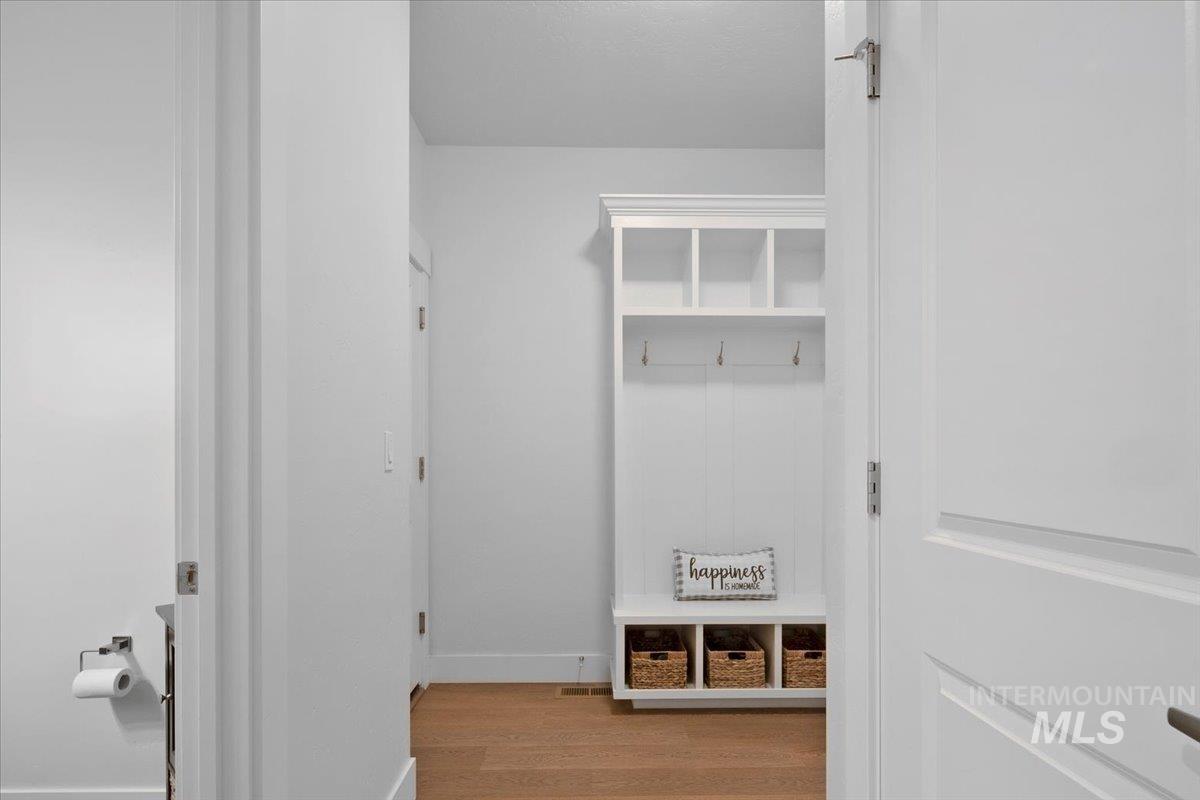 Mudroom featuring light wood-style floors and baseboards