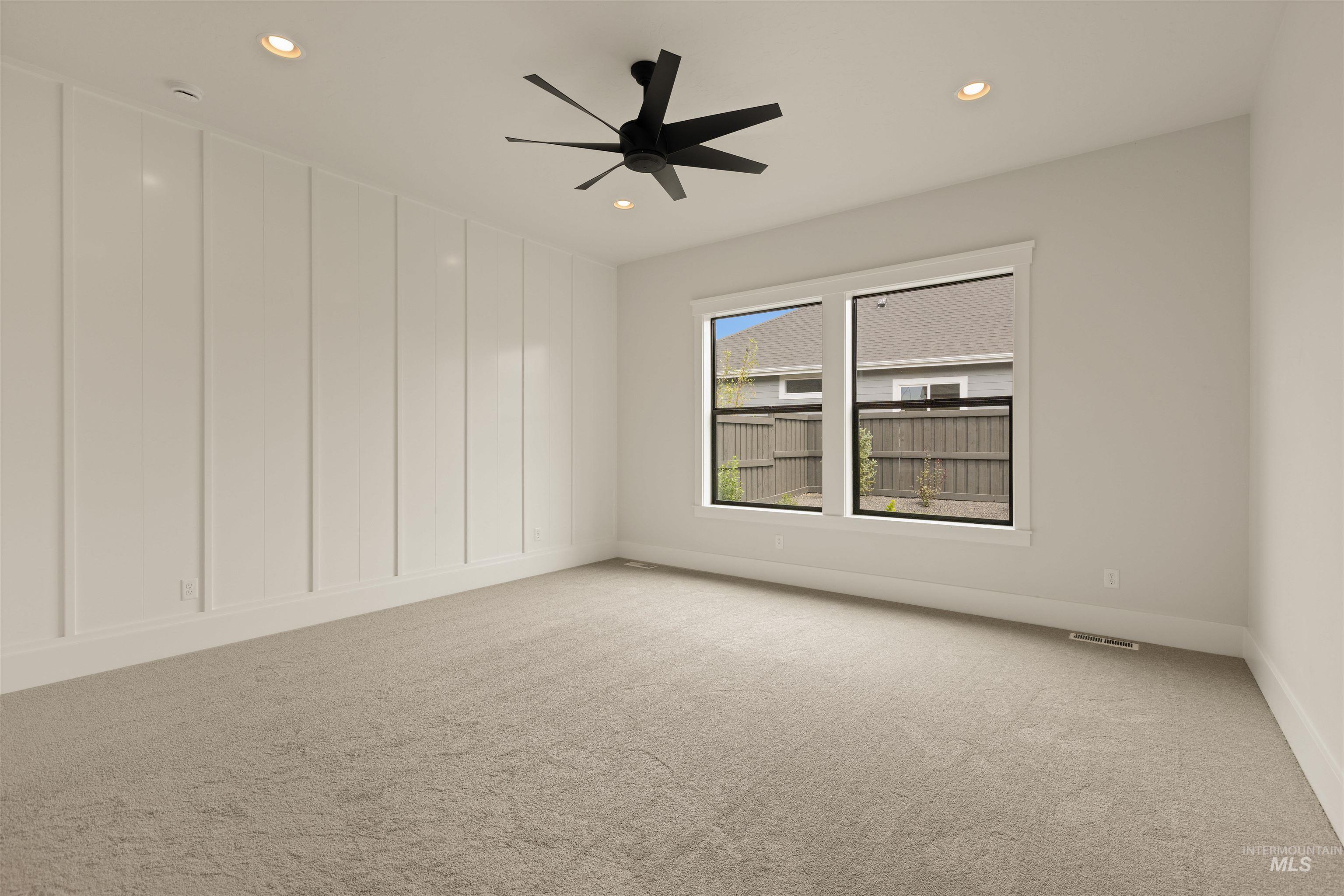 Spare room with light colored carpet, recessed lighting, and a ceiling fan