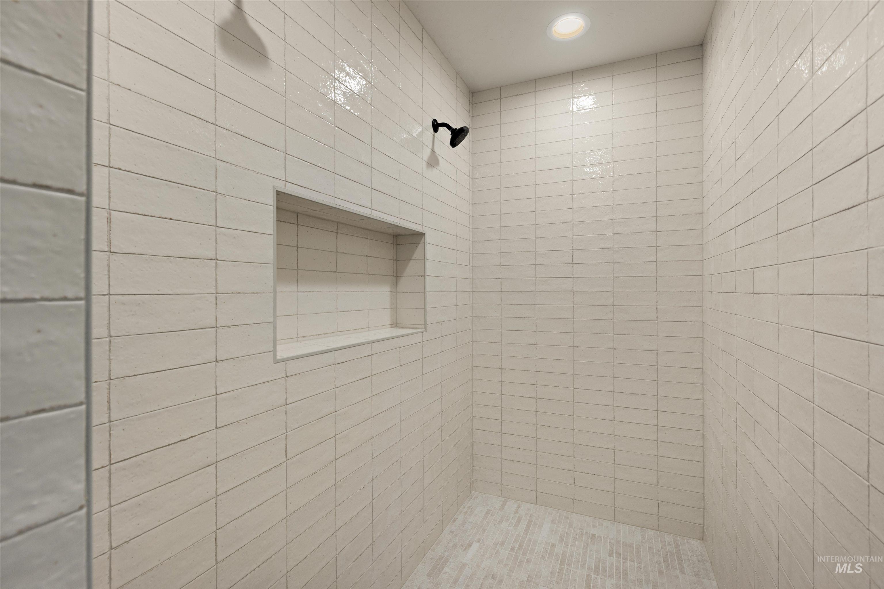 Bathroom featuring a tile shower and recessed lighting