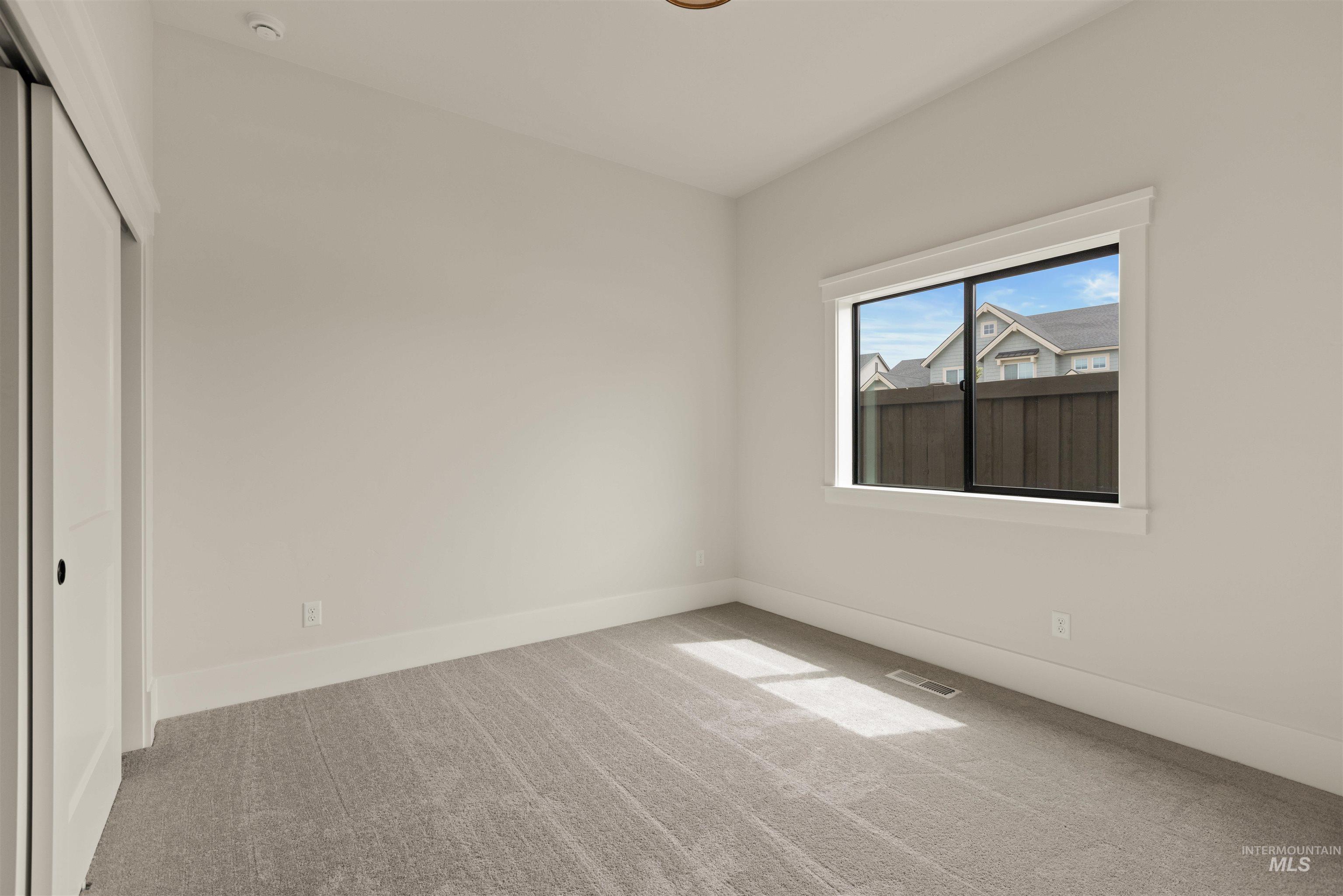 Unfurnished bedroom with carpet and a closet