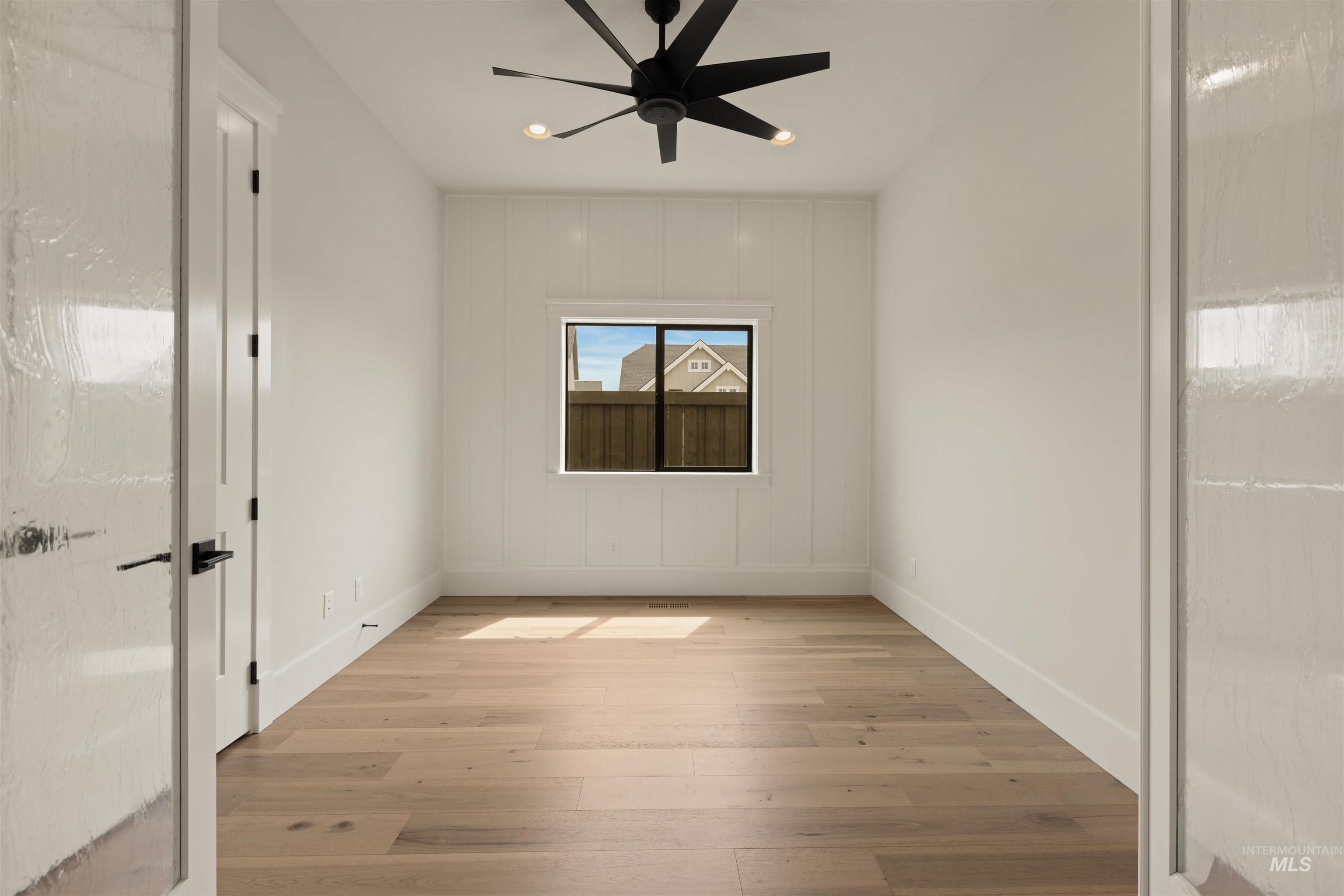 Unfurnished room with light wood finished floors and a ceiling fan