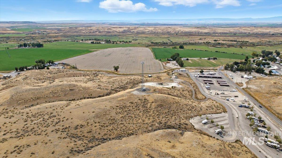 Aerial view of property's location with rural landscape and a mountainous background