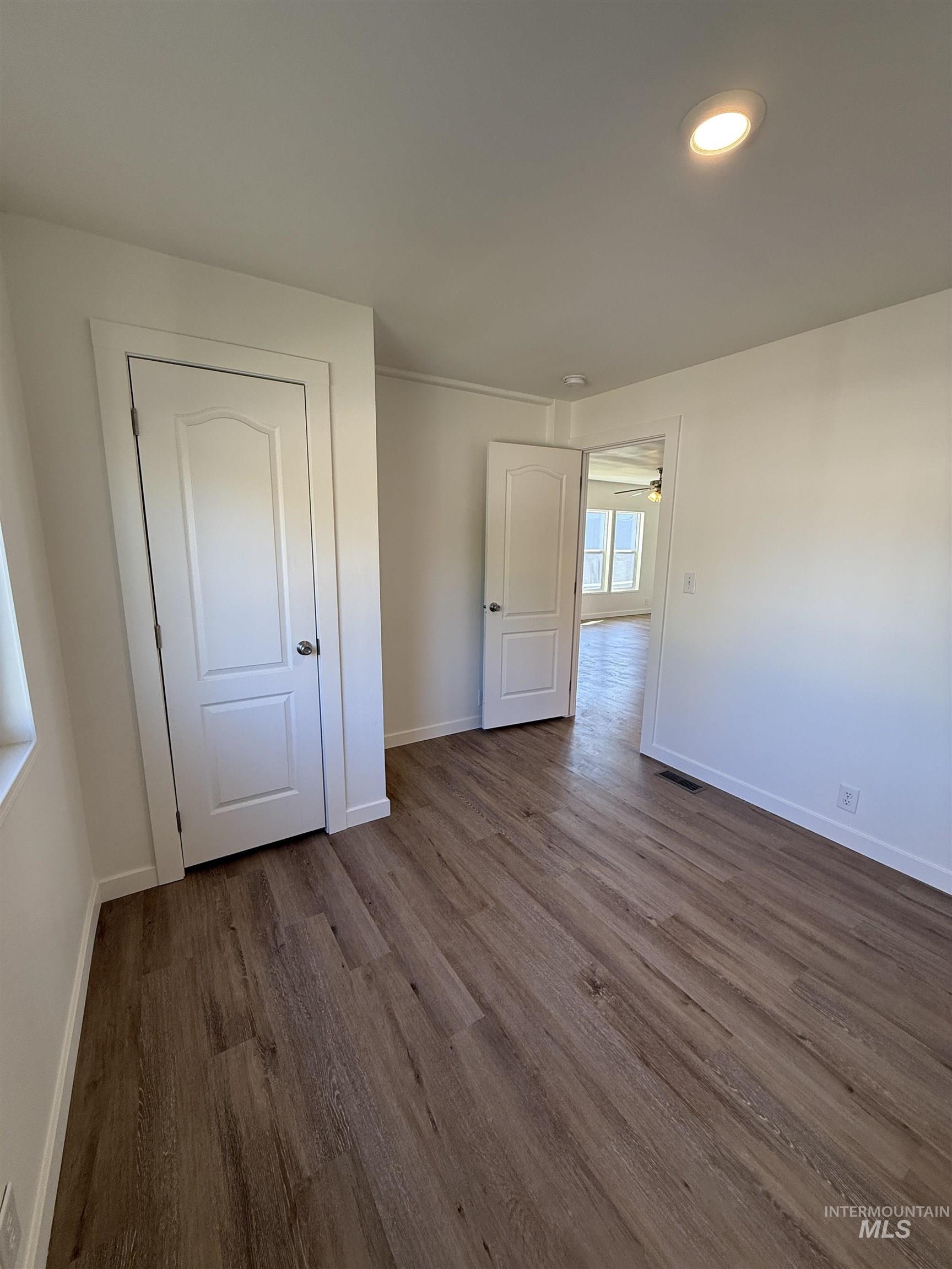 Unfurnished bedroom featuring dark wood finished floors and recessed lighting
