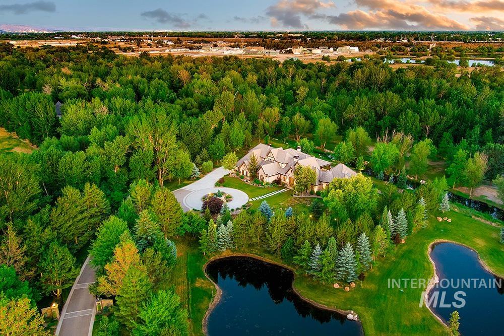 Aerial view of property and surrounding area featuring a large body of water
