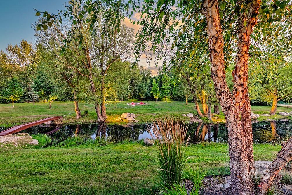 View of grassy yard with a water view