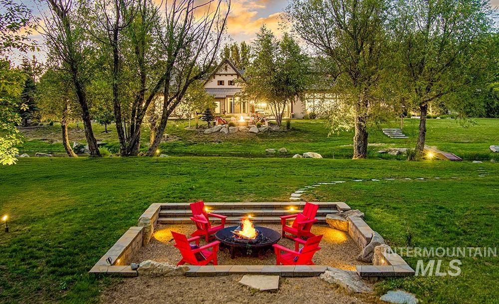 Yard at dusk with a fire pit and a lawn
