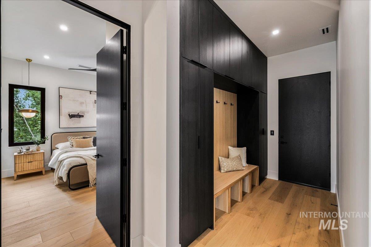 Corridor featuring light wood-type flooring and recessed lighting
