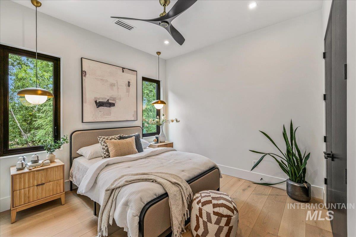 Bedroom featuring light wood finished floors, a ceiling fan, and recessed lighting