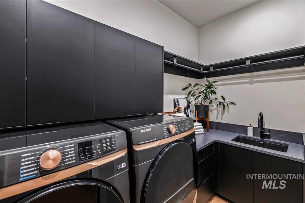 Laundry area featuring cabinet space and washer and dryer
