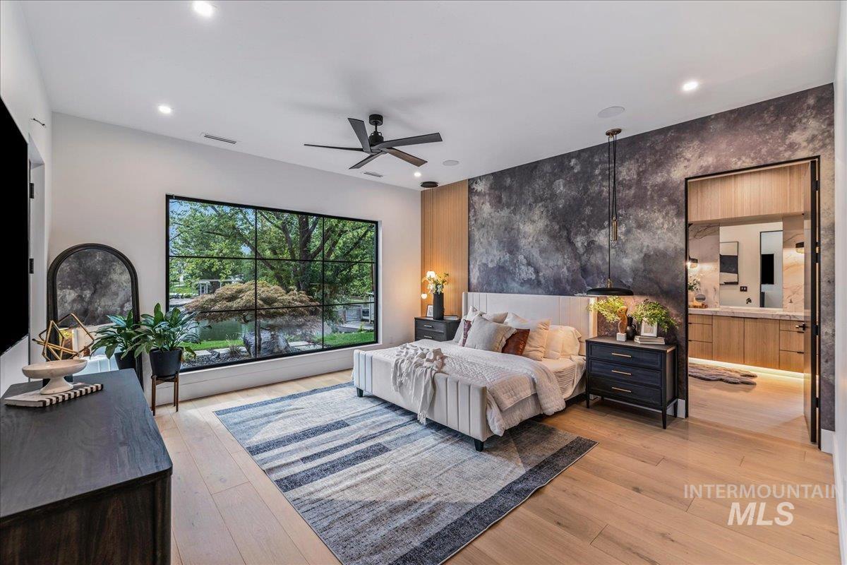 Bedroom with light wood-type flooring, a ceiling fan, and recessed lighting