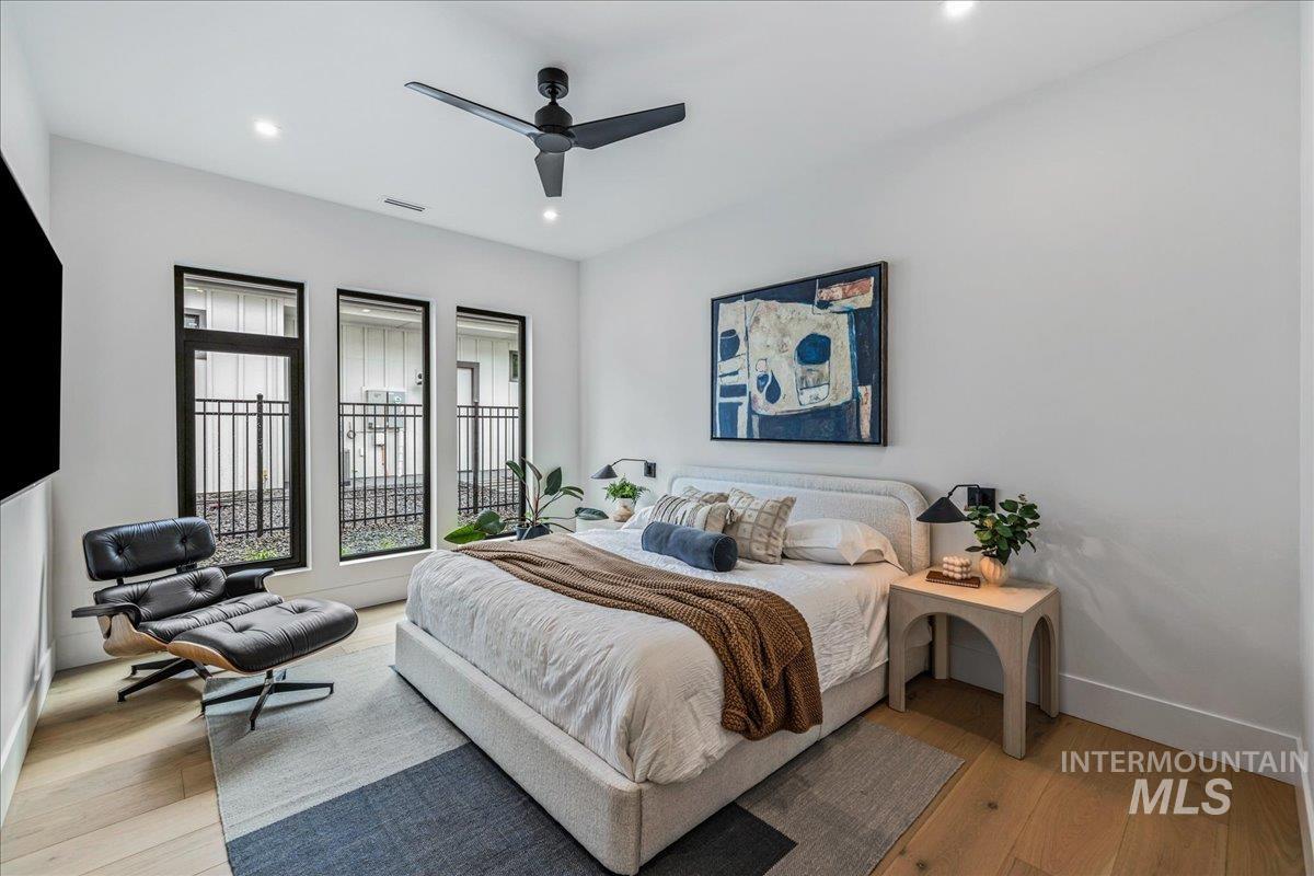 Bedroom featuring light wood-type flooring, ceiling fan, and recessed lighting