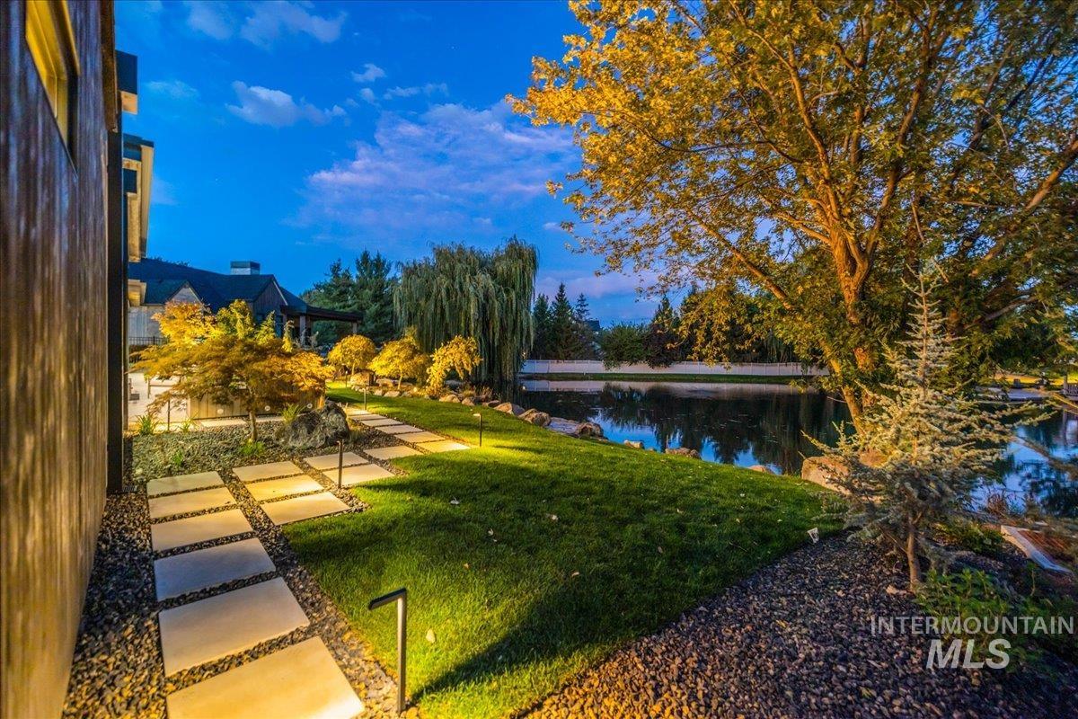 View of home's community with a yard and a water view