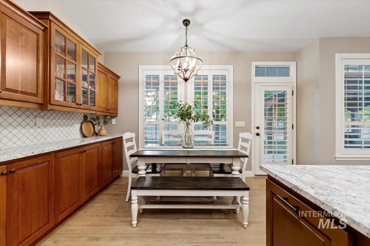 Dining area featuring light wood-style flooring and a chandelier