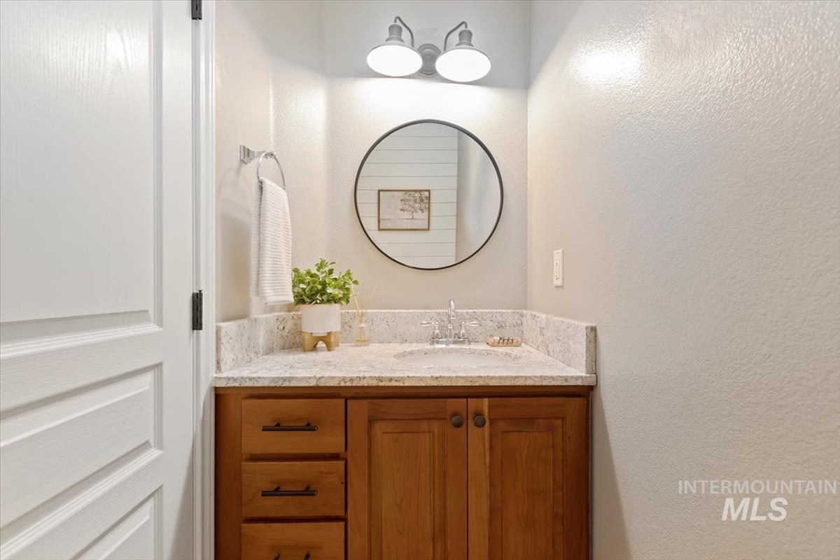 Bathroom featuring vanity and a textured wall