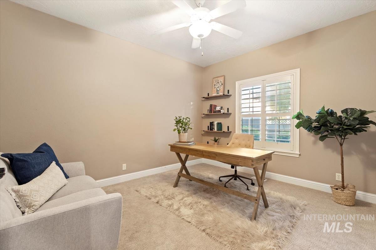 Office featuring light colored carpet and ceiling fan