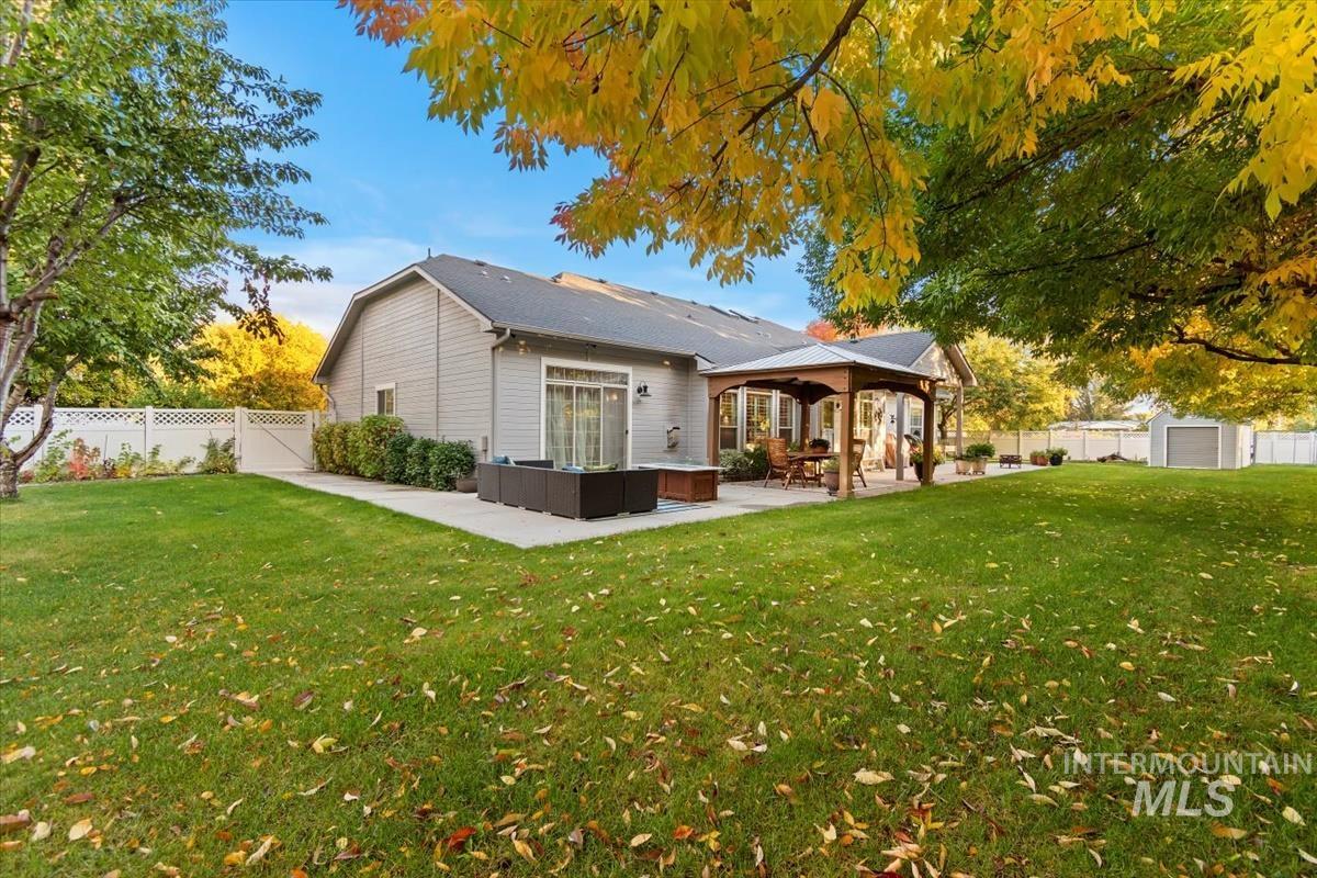 Rear view of property with a fenced backyard, a patio area, outdoor lounge area, and a gazebo