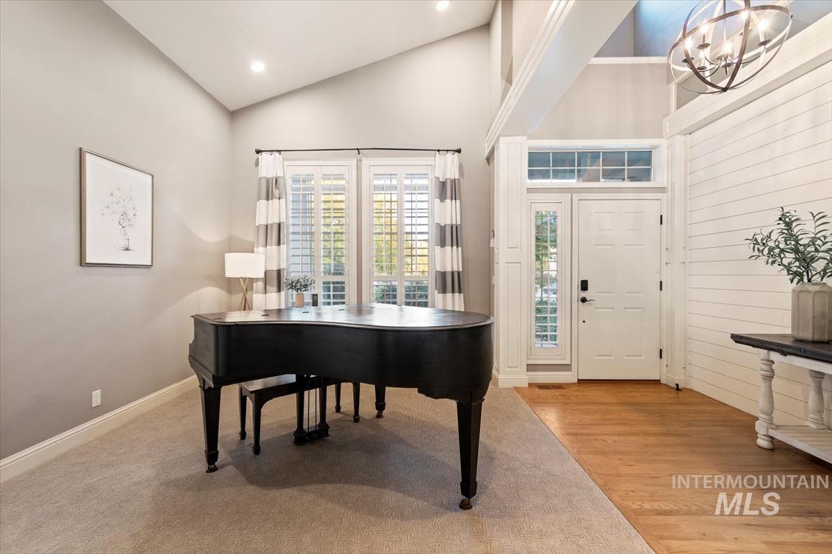 Foyer with a chandelier, light wood finished floors, high vaulted ceiling, and recessed lighting