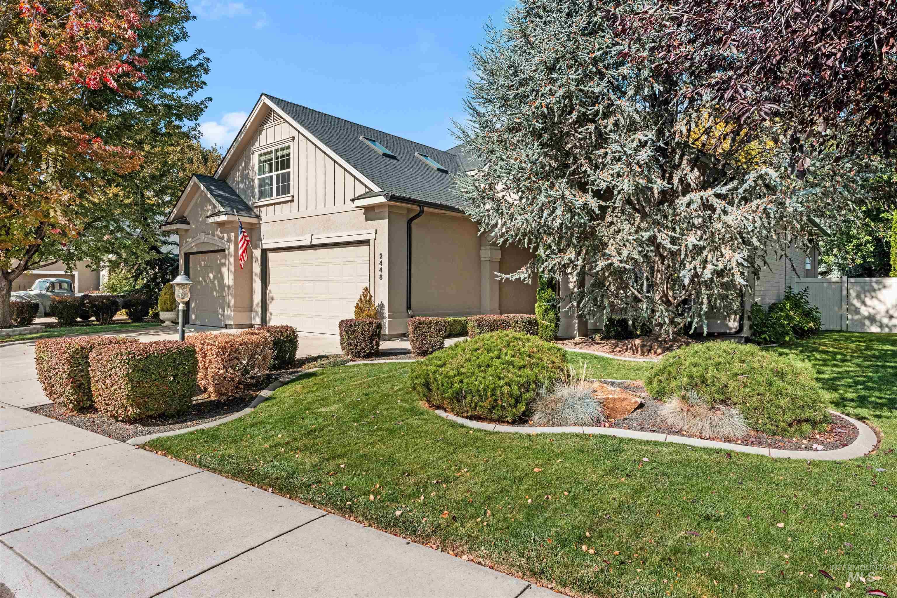 View of property exterior featuring board and batten siding, a shingled roof, and concrete driveway