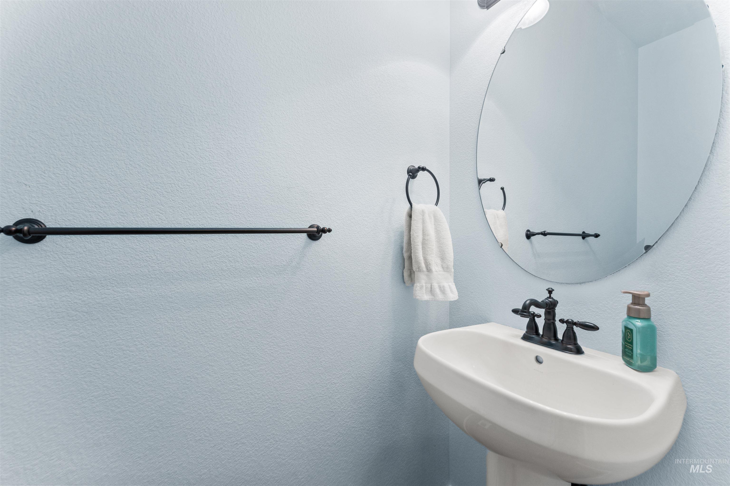 Bathroom with a sink and a textured wall
