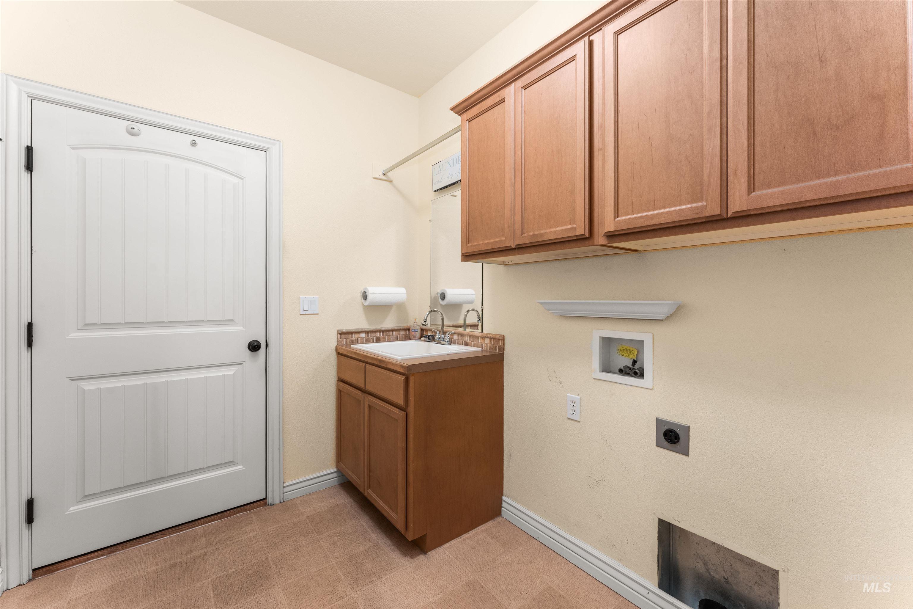 Laundry room featuring cabinet space, washer hookup, electric dryer hookup, and light floors