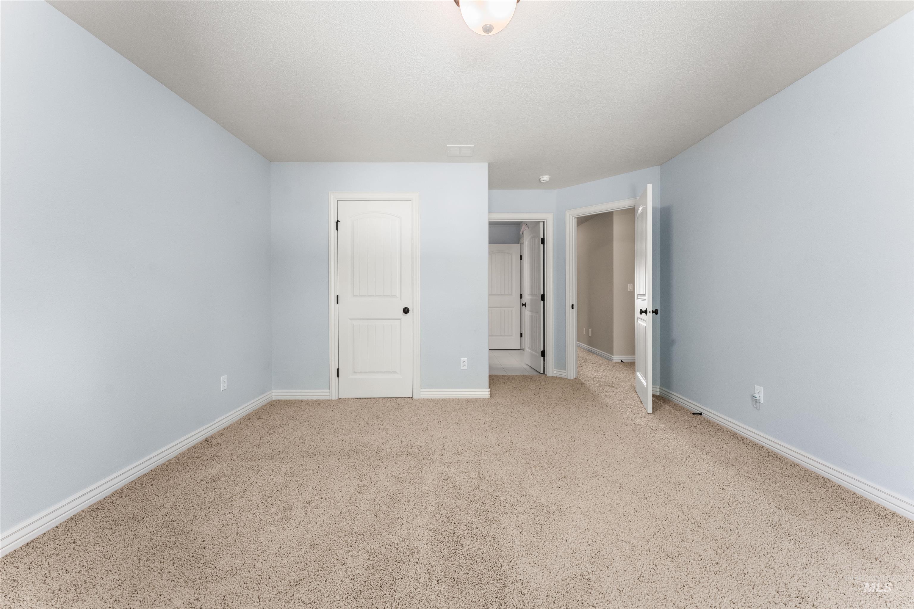 Unfurnished bedroom with carpet and baseboards
