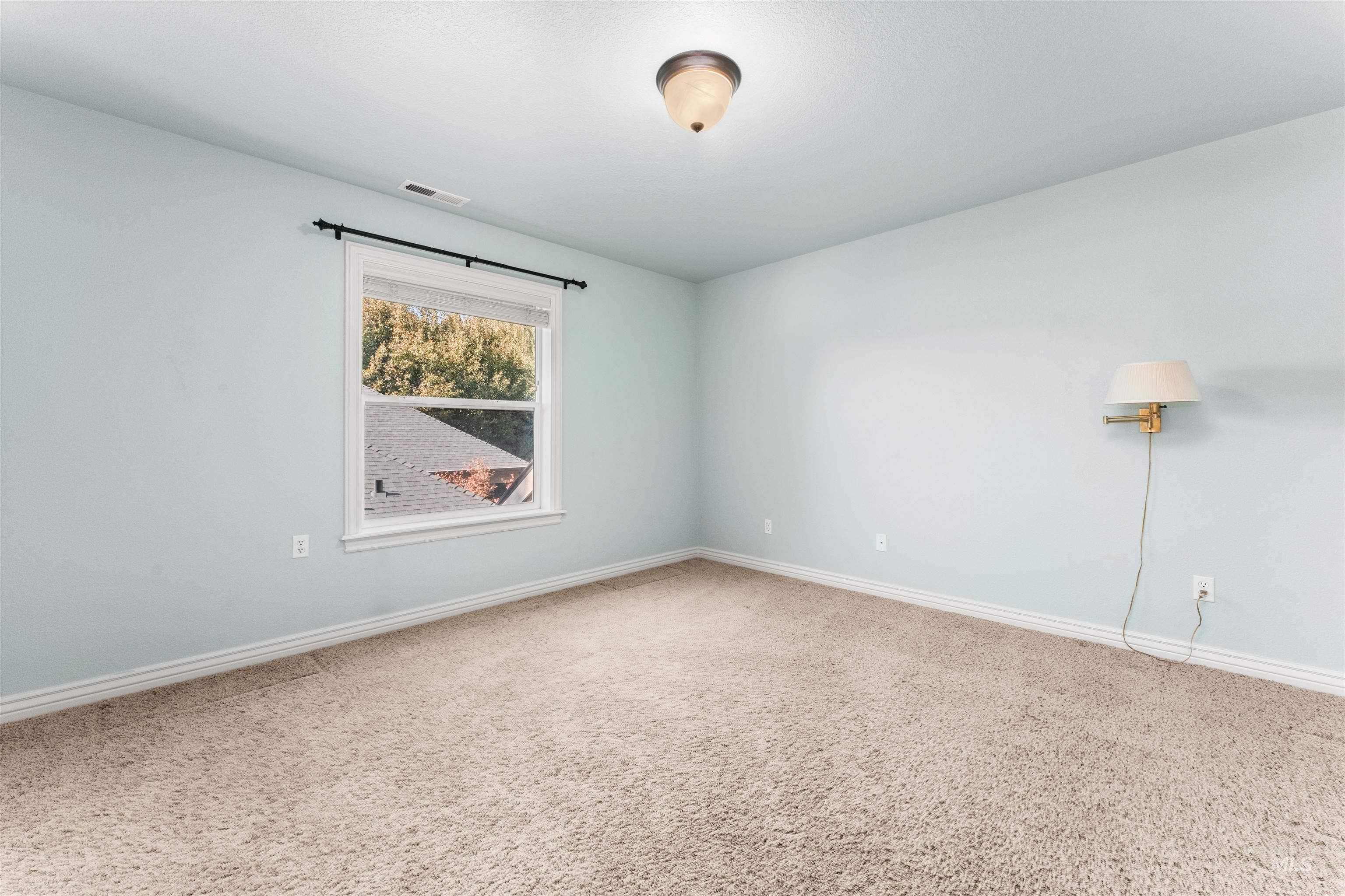 Empty room featuring baseboards and carpet floors