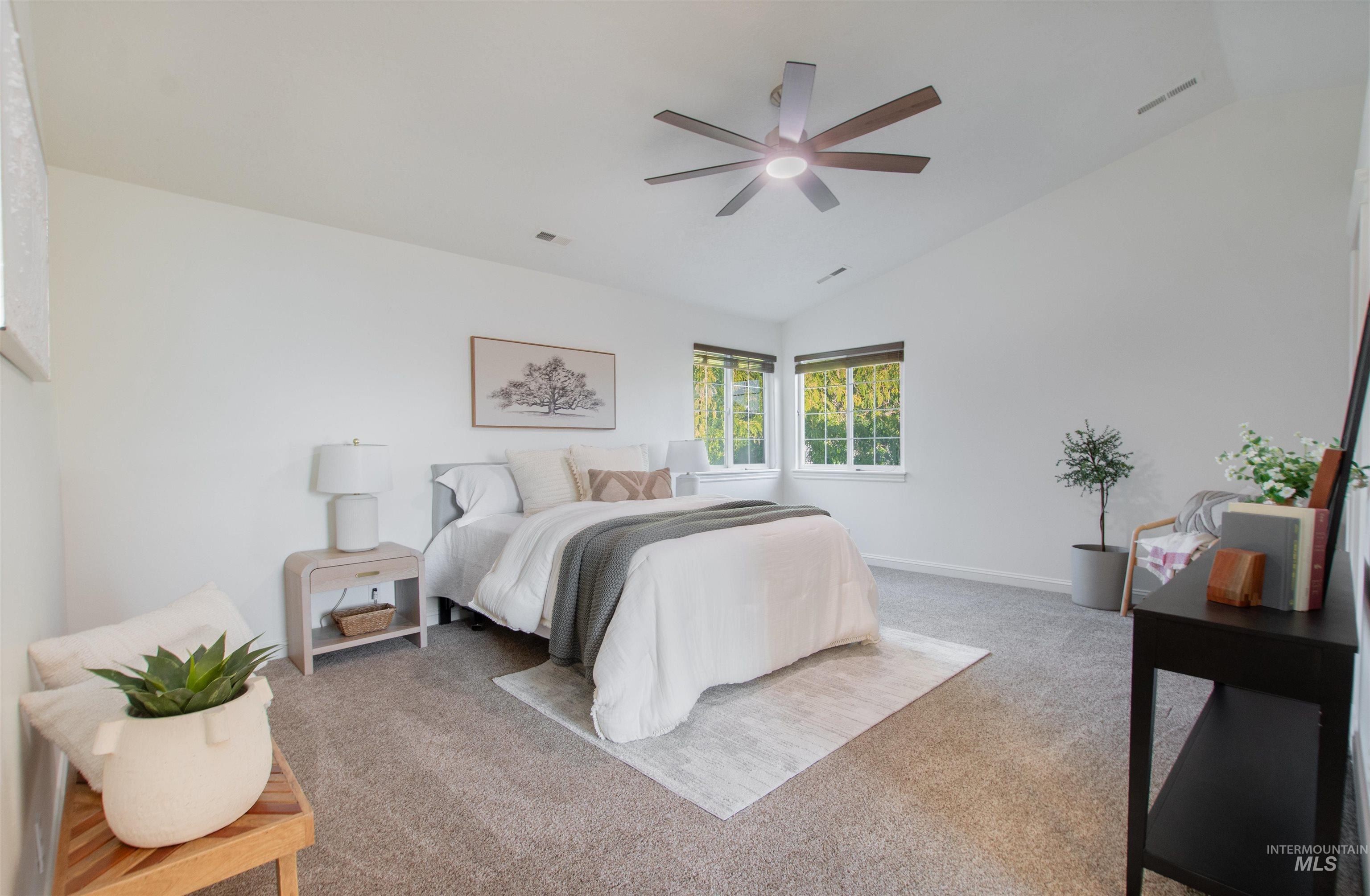 Bedroom featuring lofted ceiling, light carpet, and ceiling fan