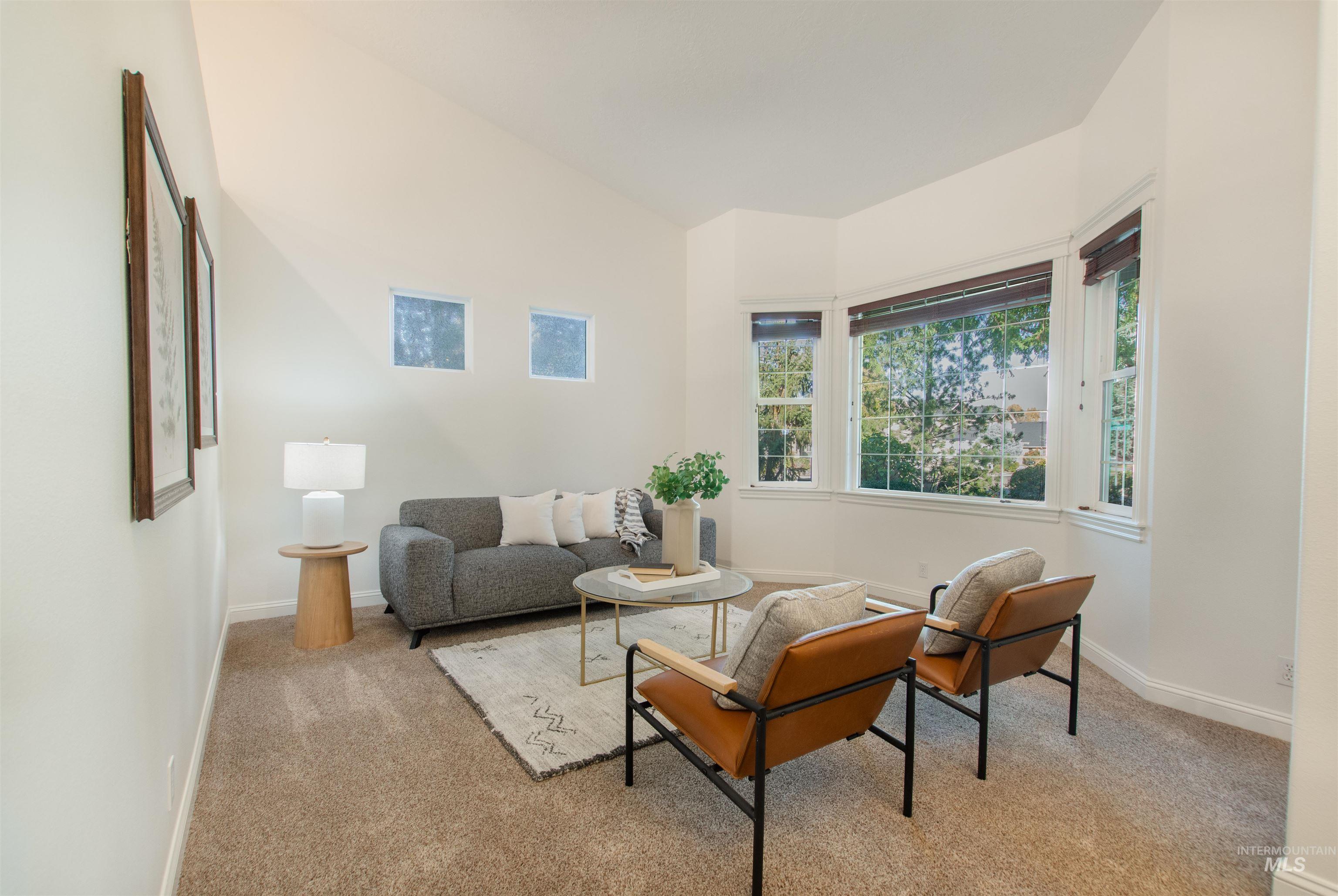 Living area with carpet flooring and baseboards