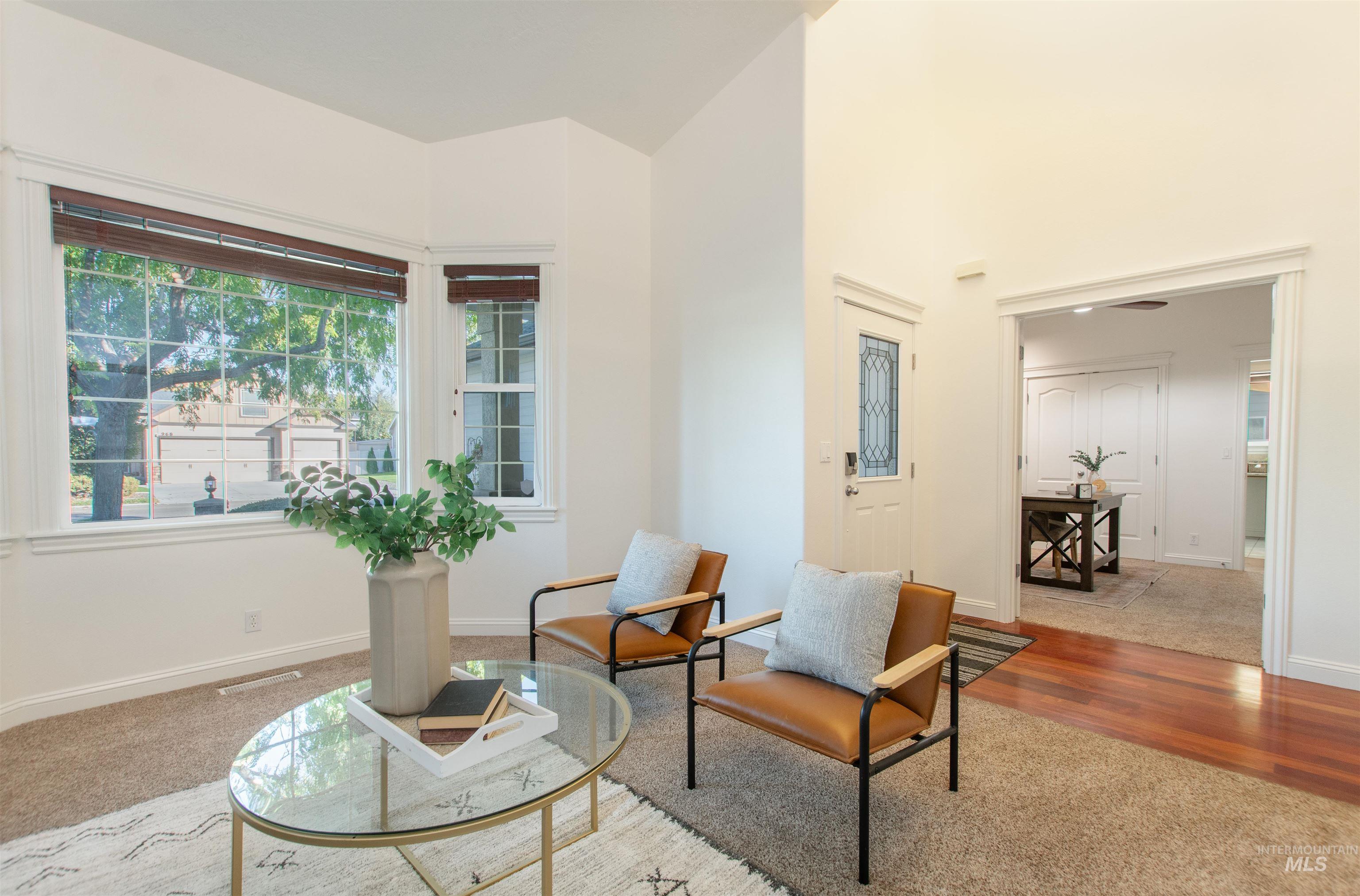 Sitting room featuring carpet and wood finished floors