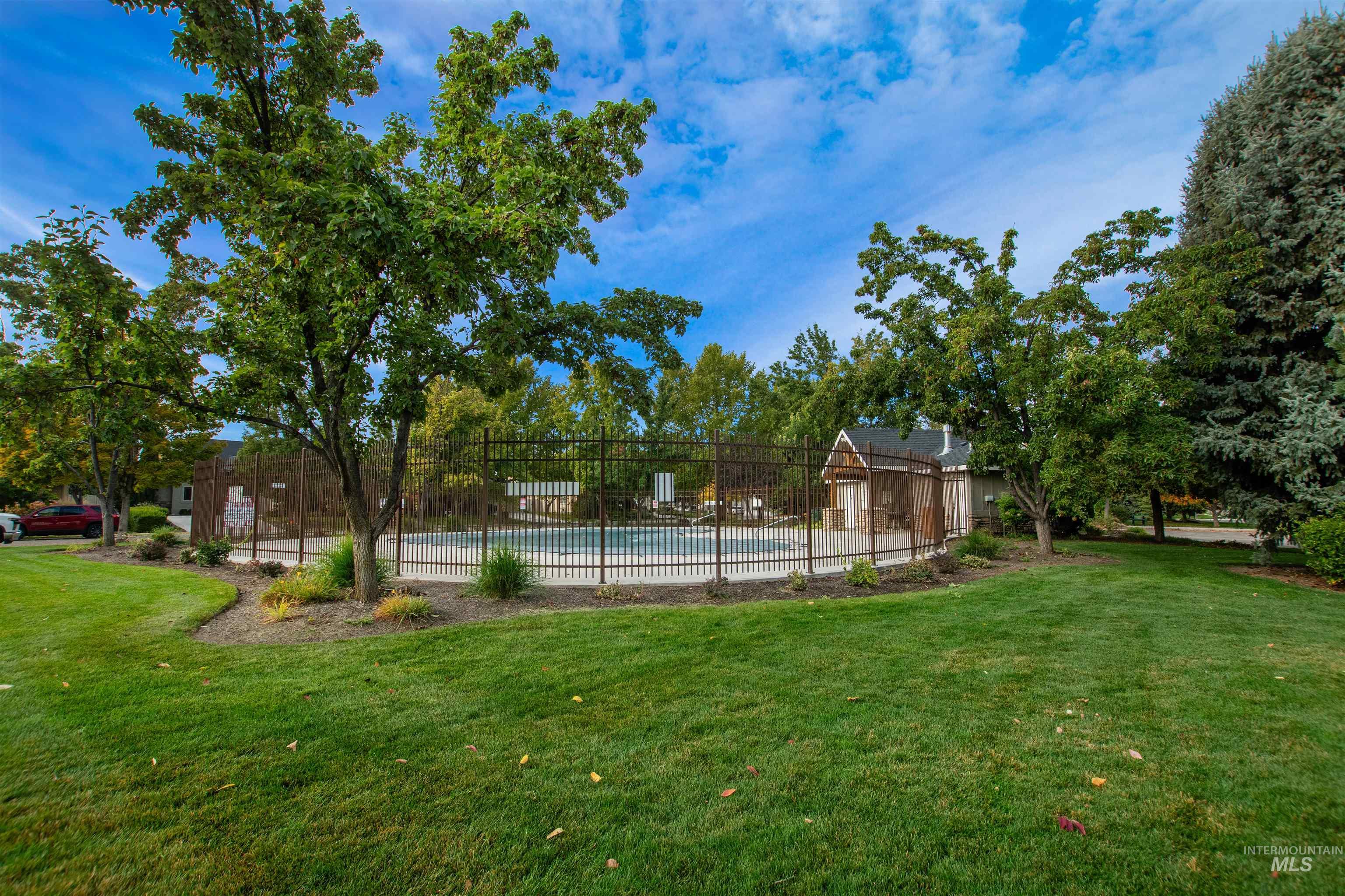 View of yard featuring a community pool and view of scattered trees