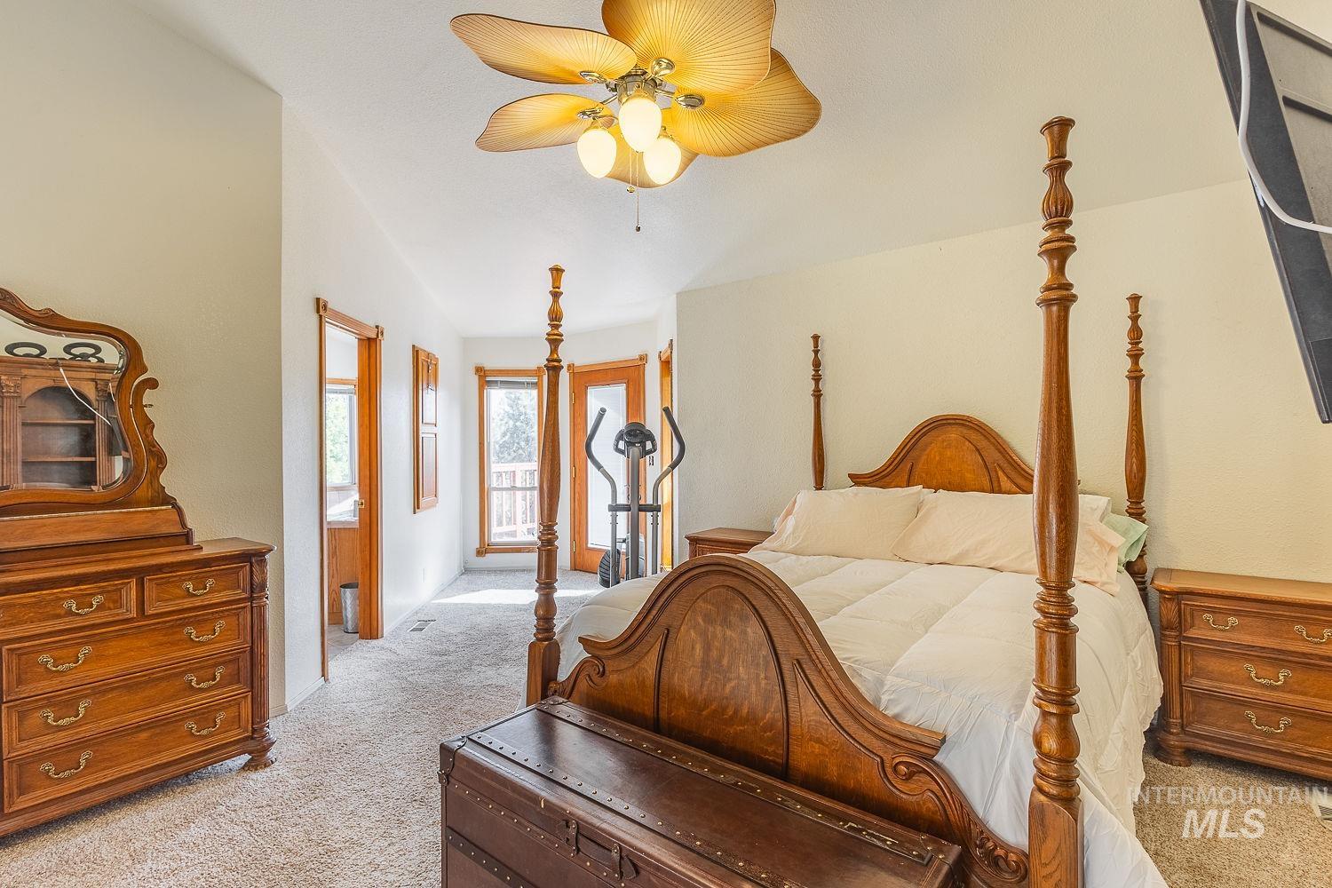 Bedroom with light colored carpet and ceiling fan