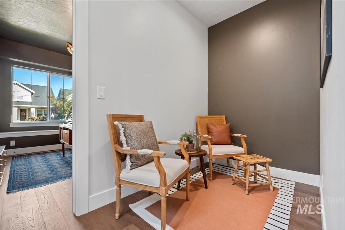 Living area featuring light wood-type flooring and baseboards