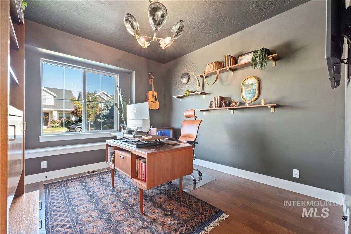 Office featuring dark wood-style flooring and a textured ceiling