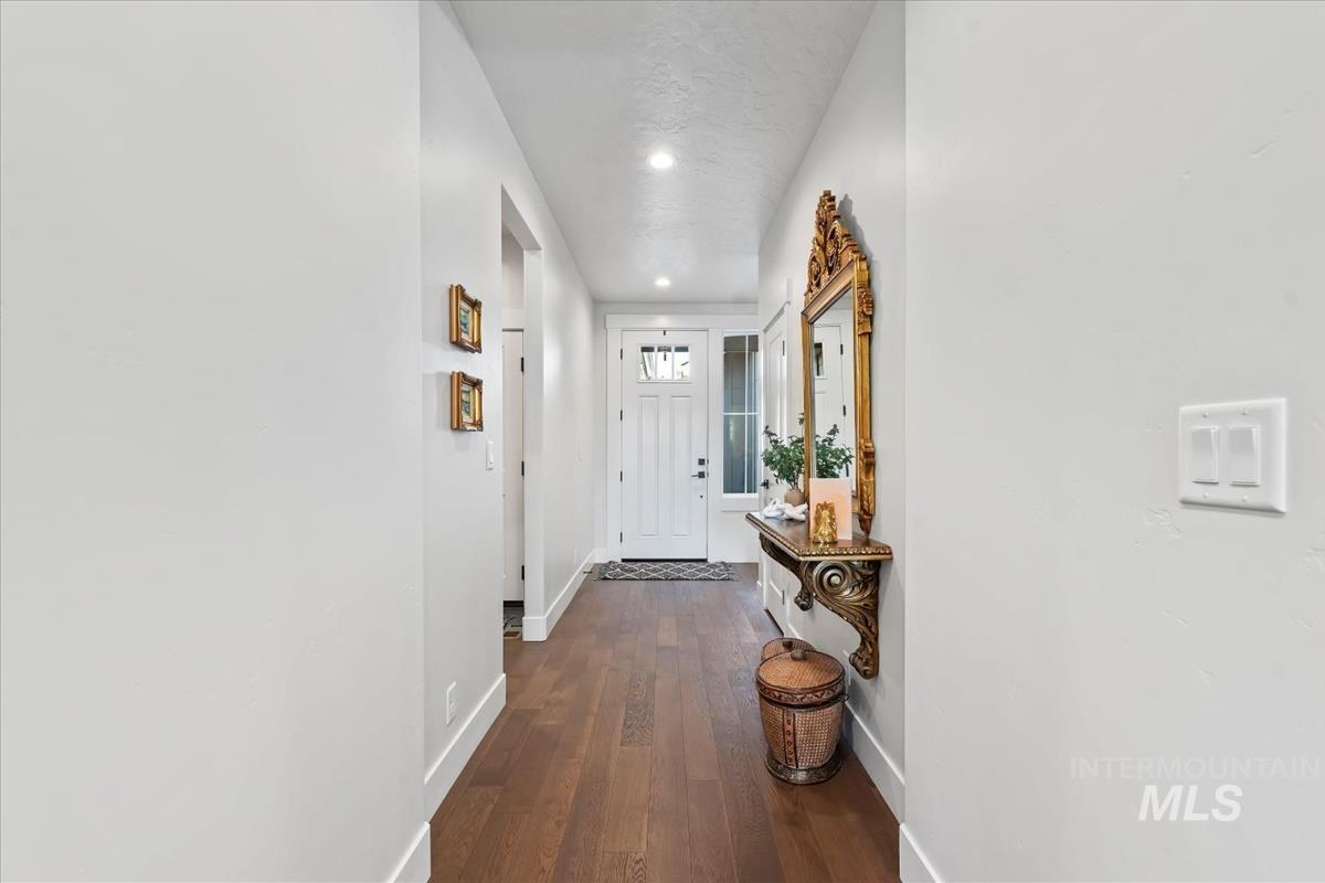 Doorway featuring wood finished floors and recessed lighting