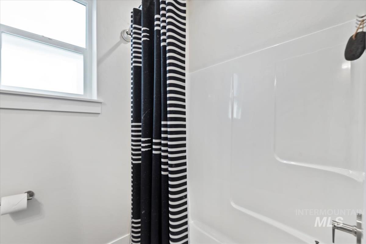 Bathroom featuring shower / tub combo with curtain