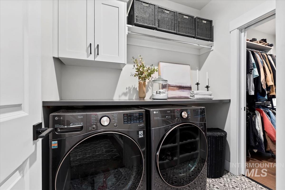 Laundry area featuring cabinet space and independent washer and dryer